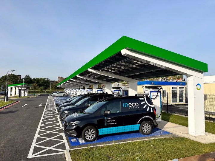 Electric vehicle charging hub with solar panels overhead at NEC Birmingham.