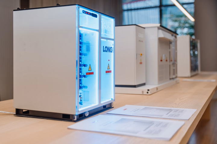 LONGi ONE integrated solar and storage portfolio displayed on a table.