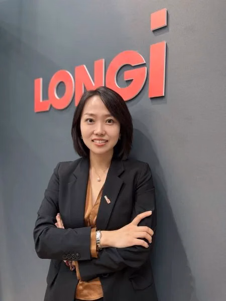 Leticia Han, General Manager UK & Ireland at LONGi Solar, in front of the LONGi logo.