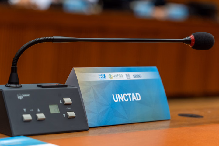Microphone on a table with UNCTAD signage during a dialogue.