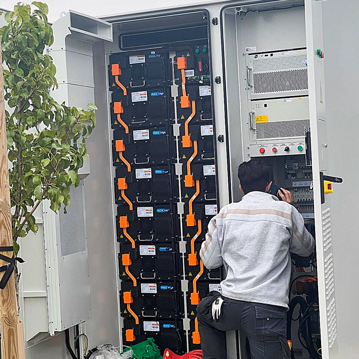 Technician performing commissioning on a LONGi OmniCube-A215 battery storage system at Turn Key Solar.