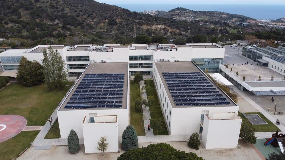 Aerial view of the Guttmann Institute in Badalona featuring LONGi solar panel installations on the rooftops.