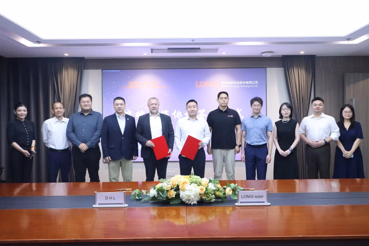 Executives from DHL and LONGi Solar posing for a photo after signing their memorandum of understanding.