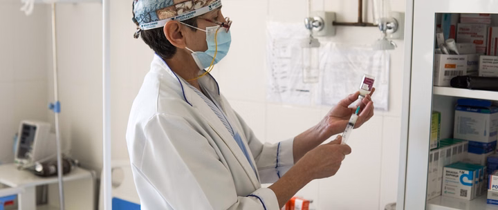 A medical worker in a hospital in Ukraine preparing medication for a patient.