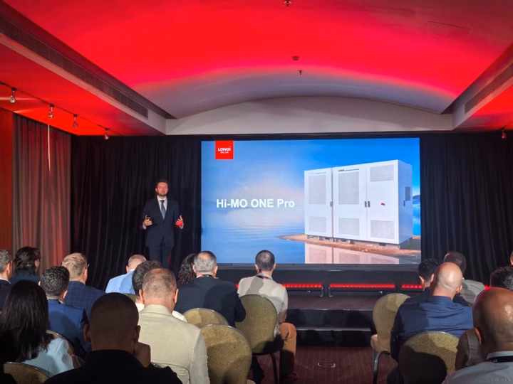 LONGi presenter unveiling the Hi-MO One Pro energy storage solution at an event in Europe.